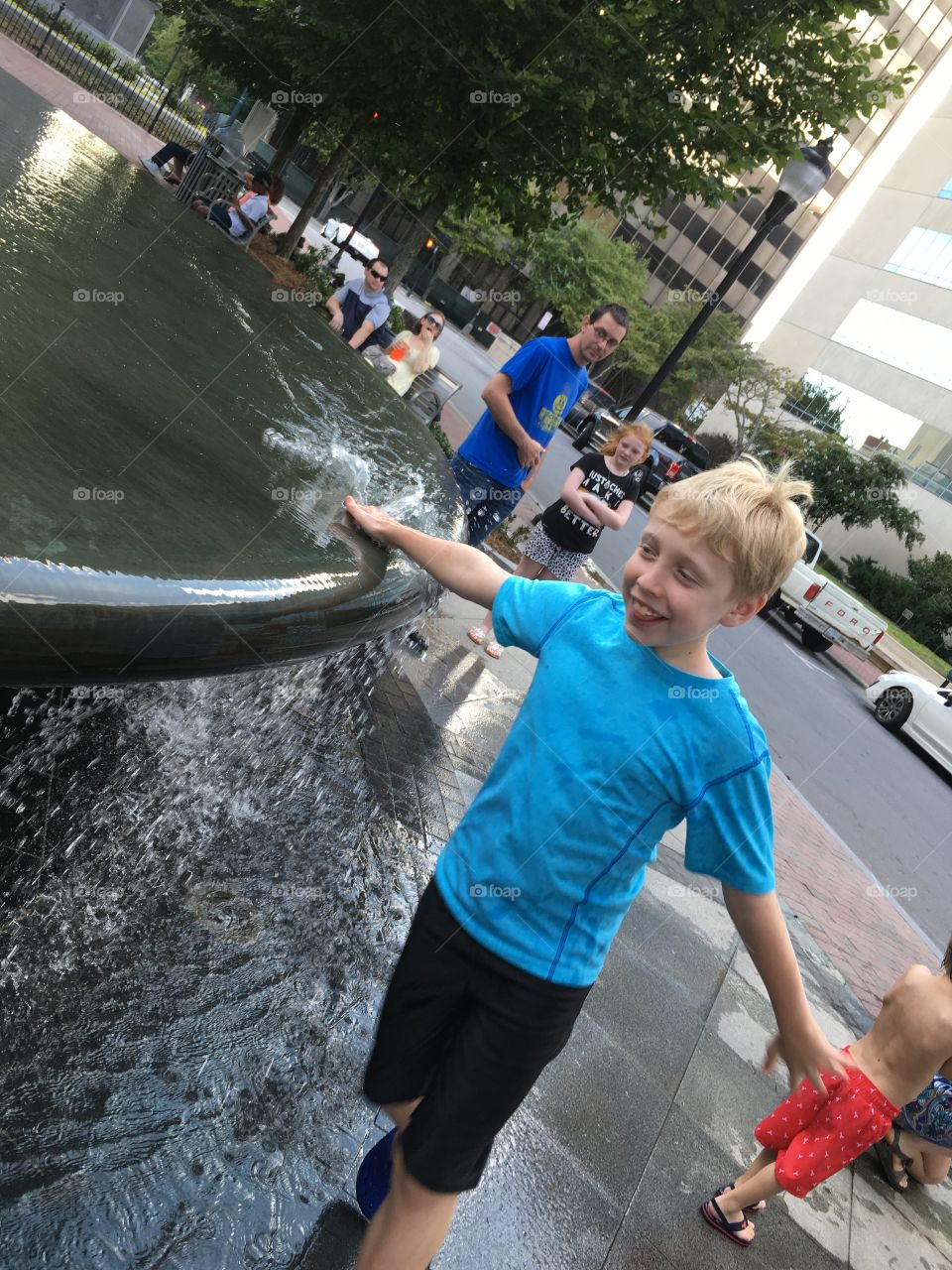 Boy Playing in the Fountain 