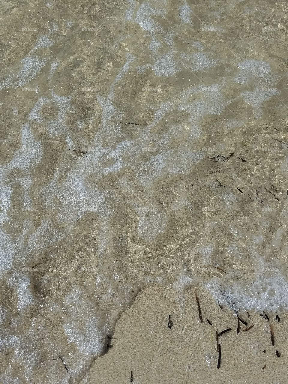 rocks in a clean ocean with sand so clean