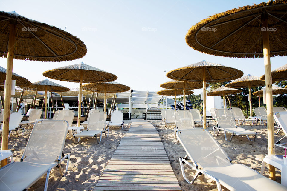 organized beach. organized beach with deck chairs and umbrellas