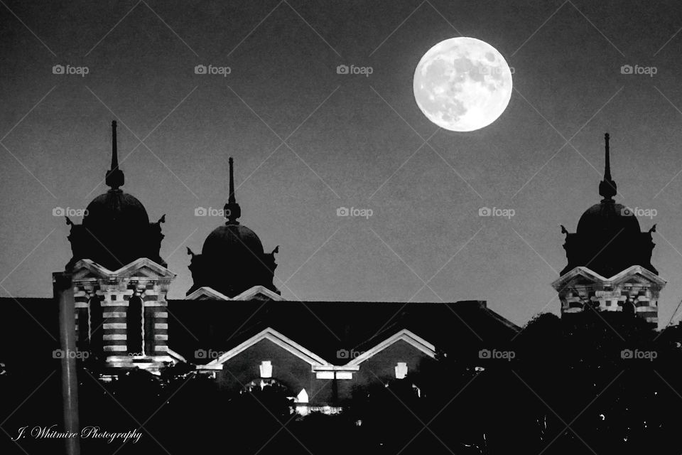 Looking across at Ellis Island as a full moon rises, the historic immigration building that was a sight for sore eyes for many that endured a long voyage