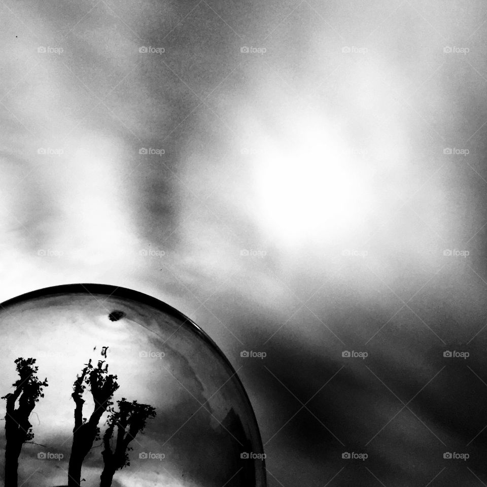 Crystal sphere on dramatic sky 