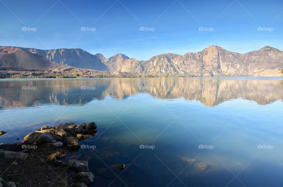 Beautiful nature background Segara Anak Lake in early morning. Mount Rinjani is an active volcano in Lombok, indonesia. Soft focus due to long exposure.