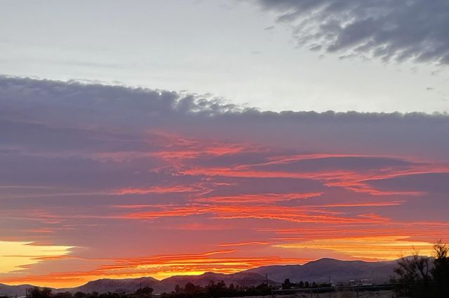A gorgeous sunset with mountains below!