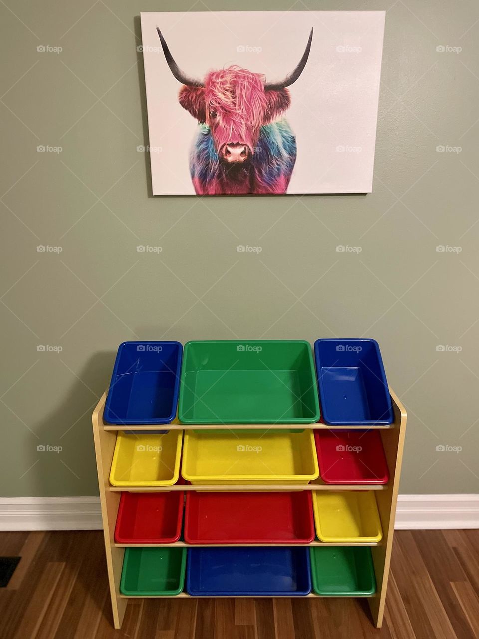 Empty toy bins in a toddlers playroom, highland cow picture above a toy organizer, colorful playroom, colorful toy organizer, toy organizer from Amazon, sorting out toys, toy sorter for a toddler, colorful and creative