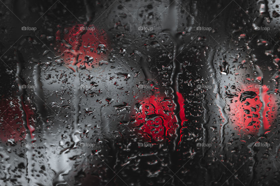 Droplets on a bus window glass, it was hard rain in a city and I love the texture and shape the droplets made