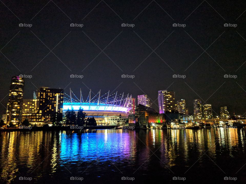 Stunning lit up stadium downtown with reflection in the water