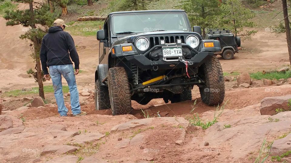 Spotting for the Jeep to make sure the tires go in the right place.