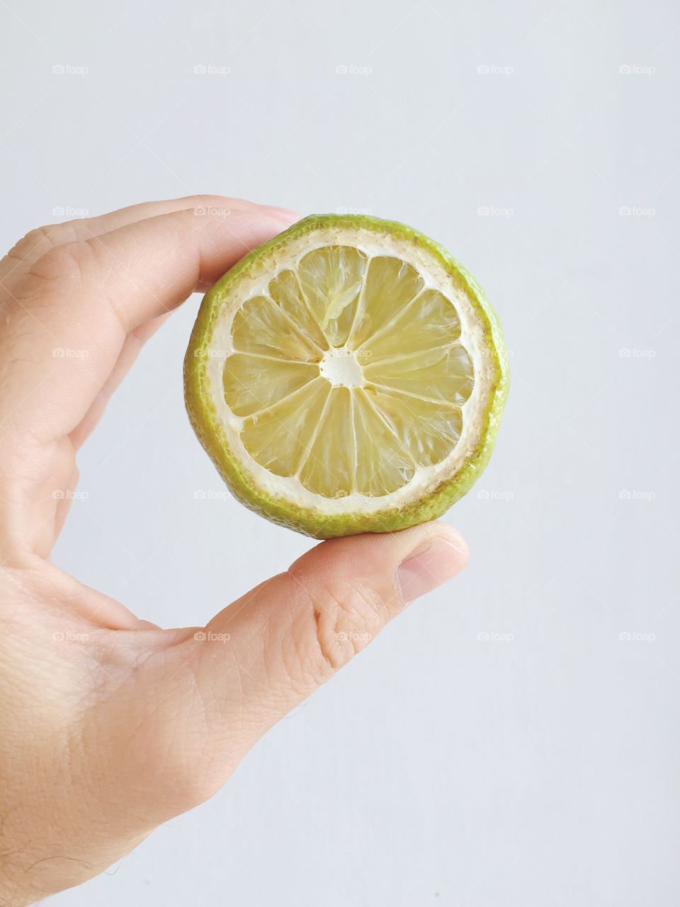 A person holding lemon slice