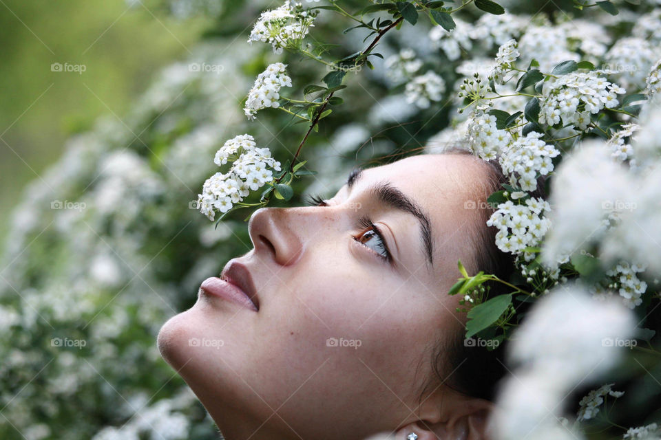 Beautiful woman in a sea of white flowers