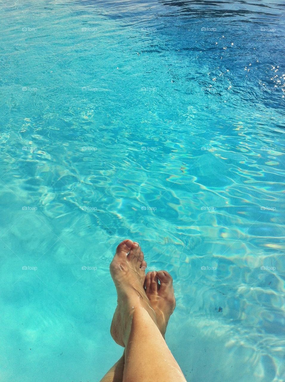 Feet by the swimming pool