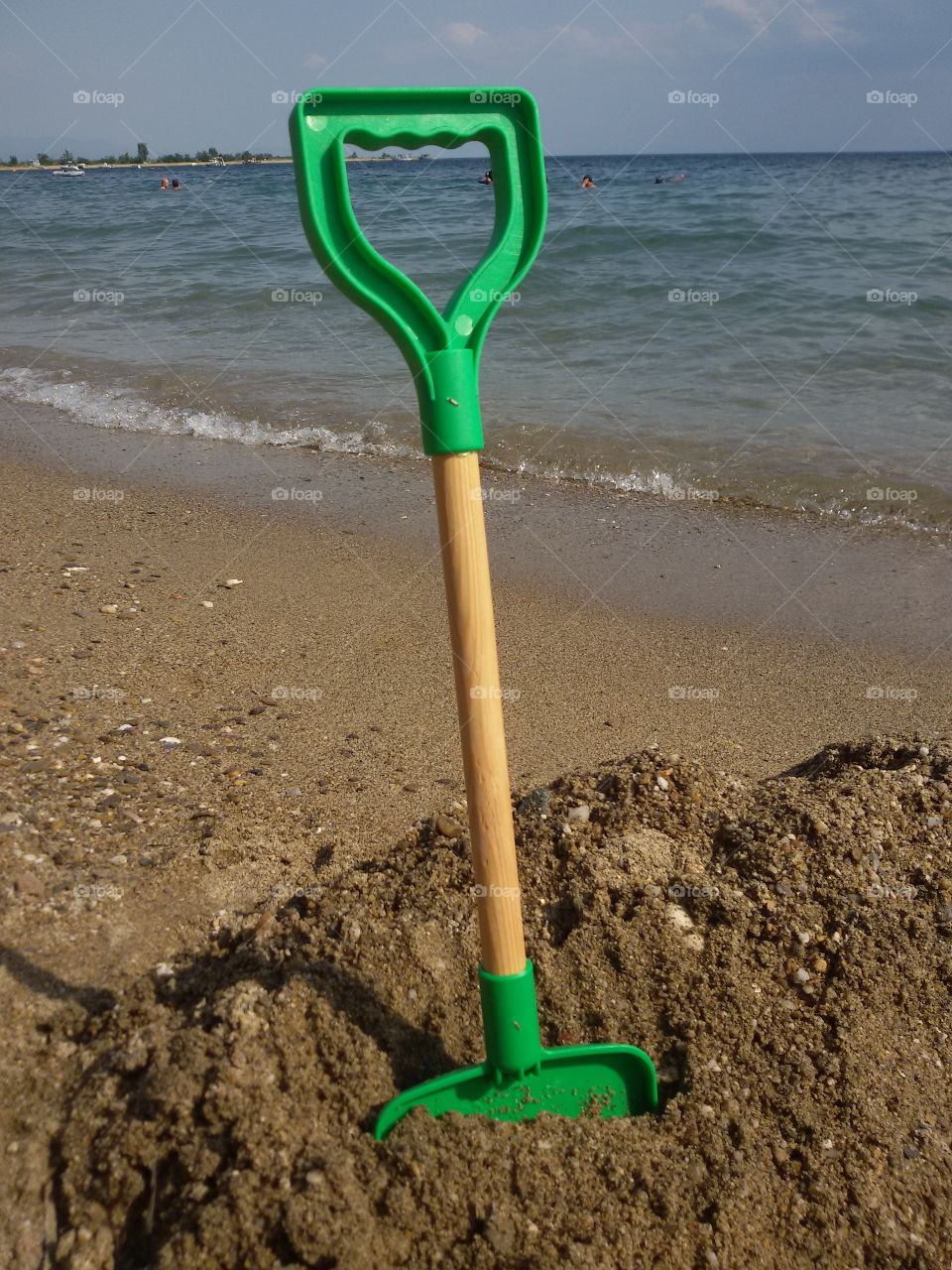 Kids rake on the beach