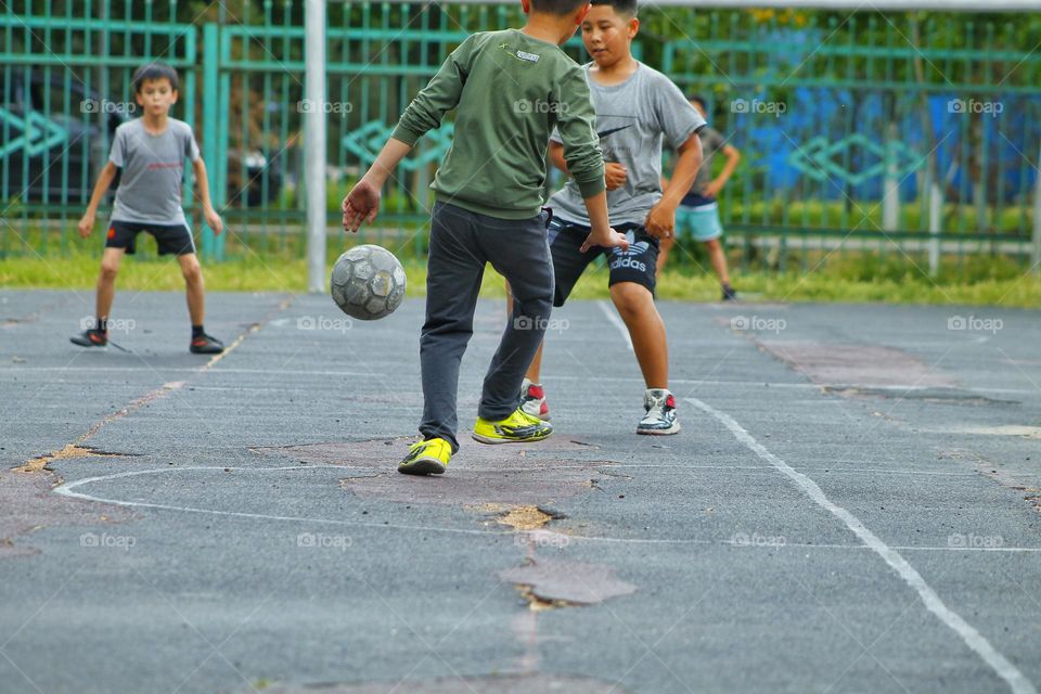 children in the old stadium play football.