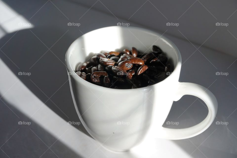 Coffee beans in coffee cup