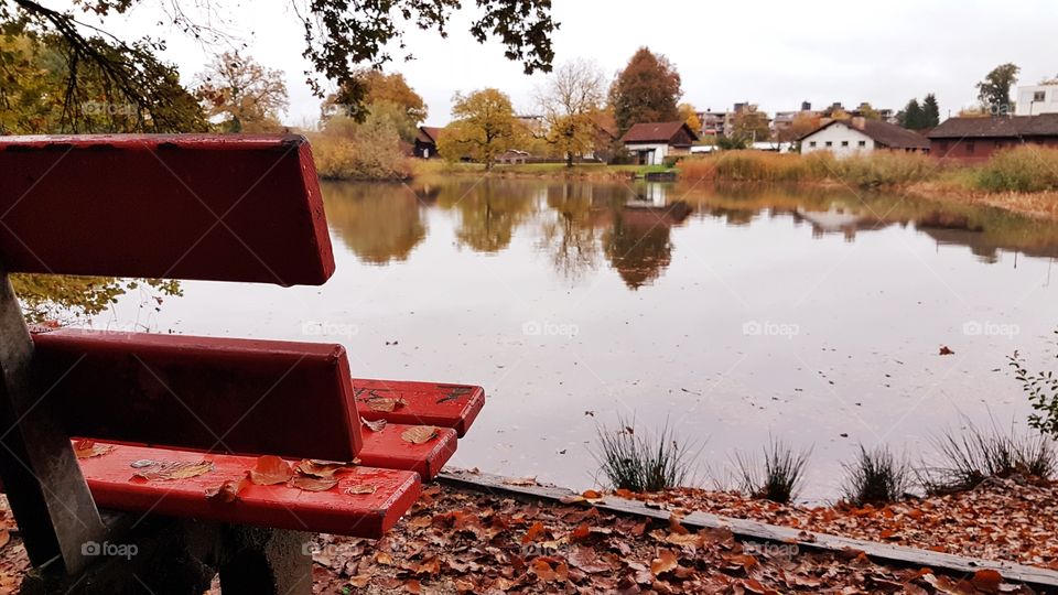 Red bench by the lake