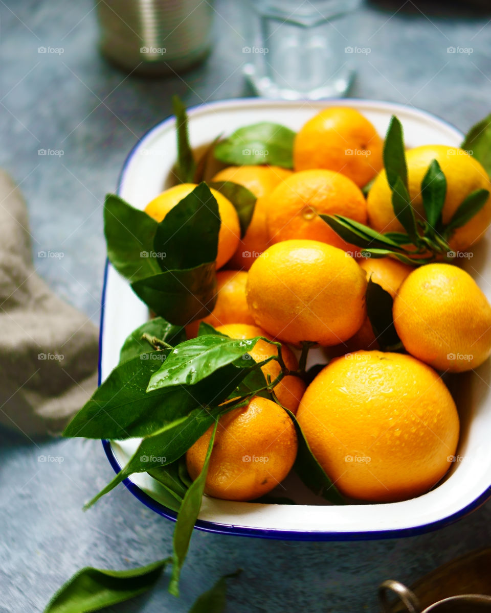 bowl of tangerines with leaves