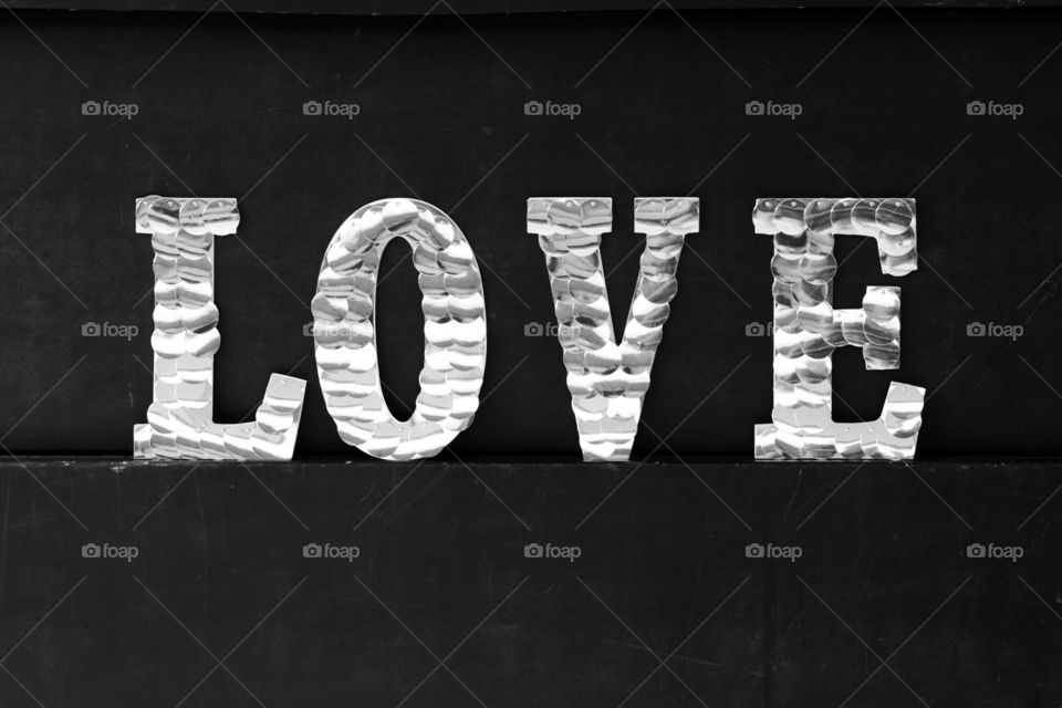 A Black and white photo of the word Love spelled out 