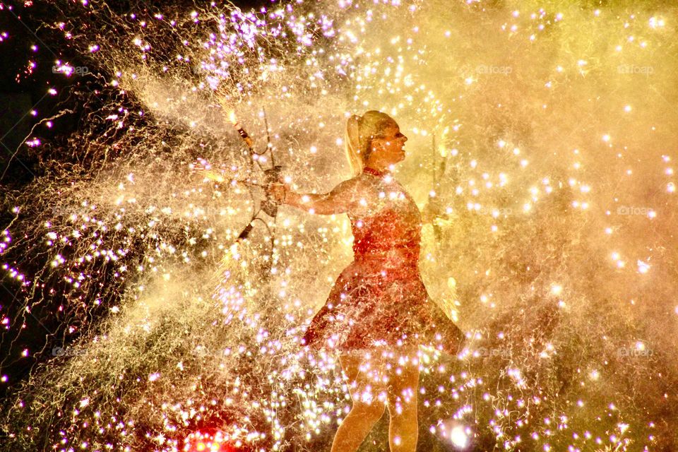 Fireworks bursting all around a young woman!