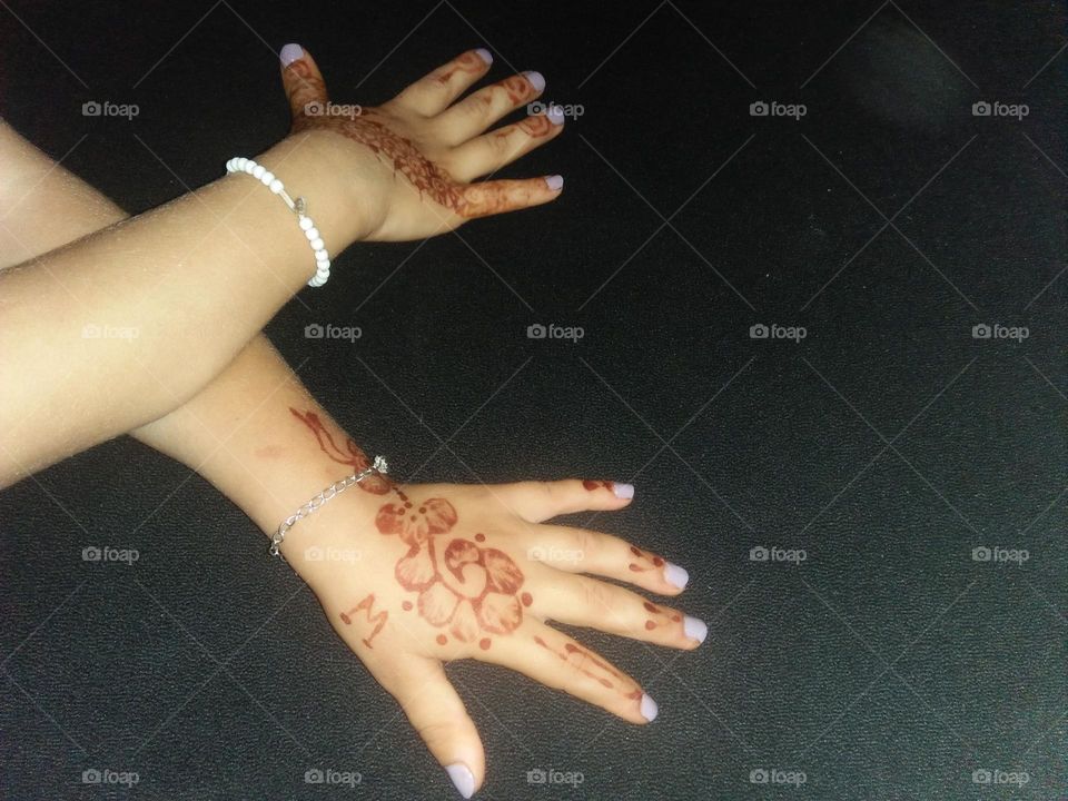 Two beautiful hands decorated by henna.