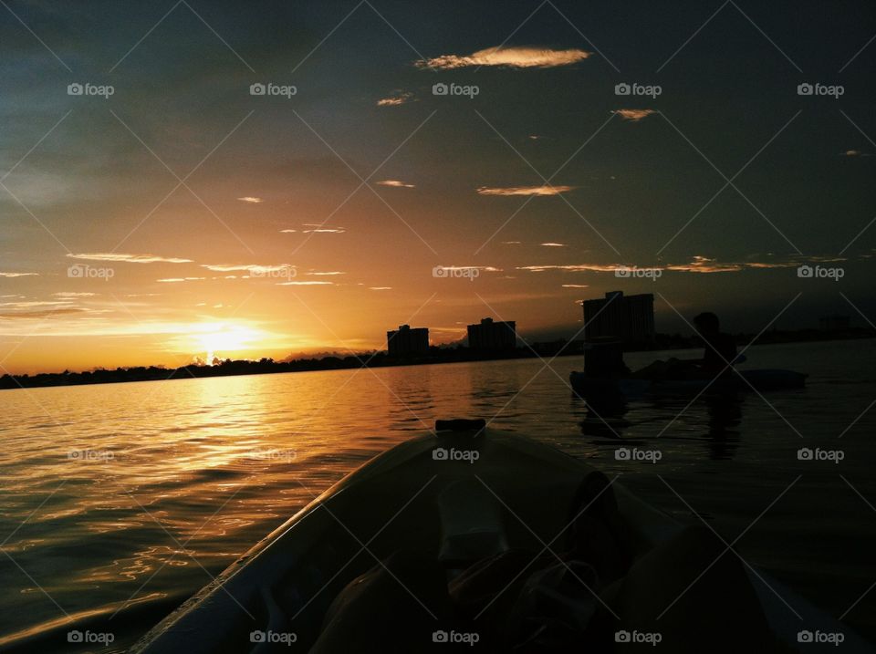 Sunset. Kayaking in bay