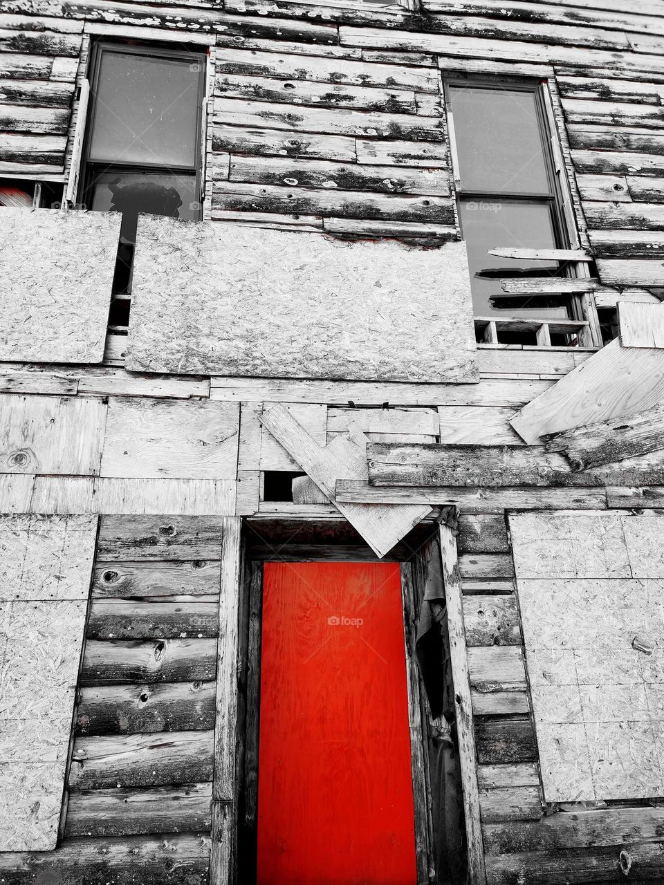 A bright red door is the only highlight to this dilapidated former business which is now a homeless refuge