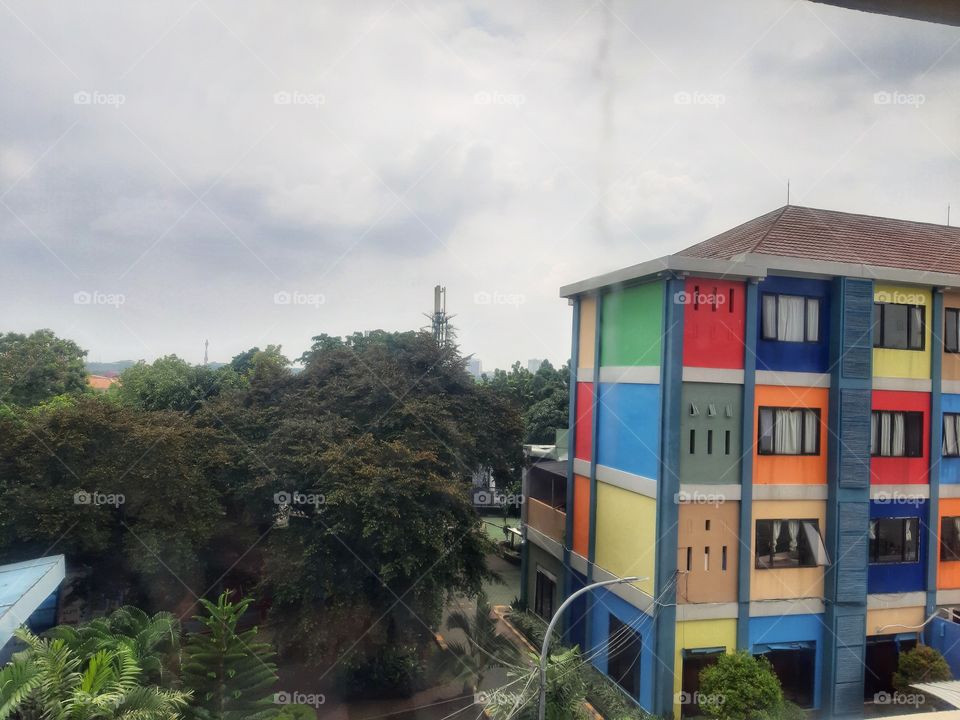 colorful building surrounding with trees in a bright day