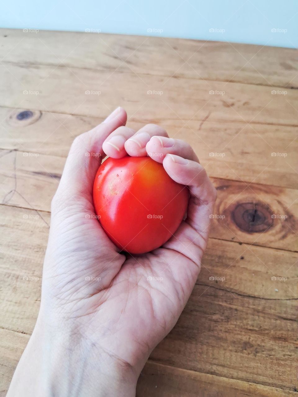 Fresh red tomatoes in hand