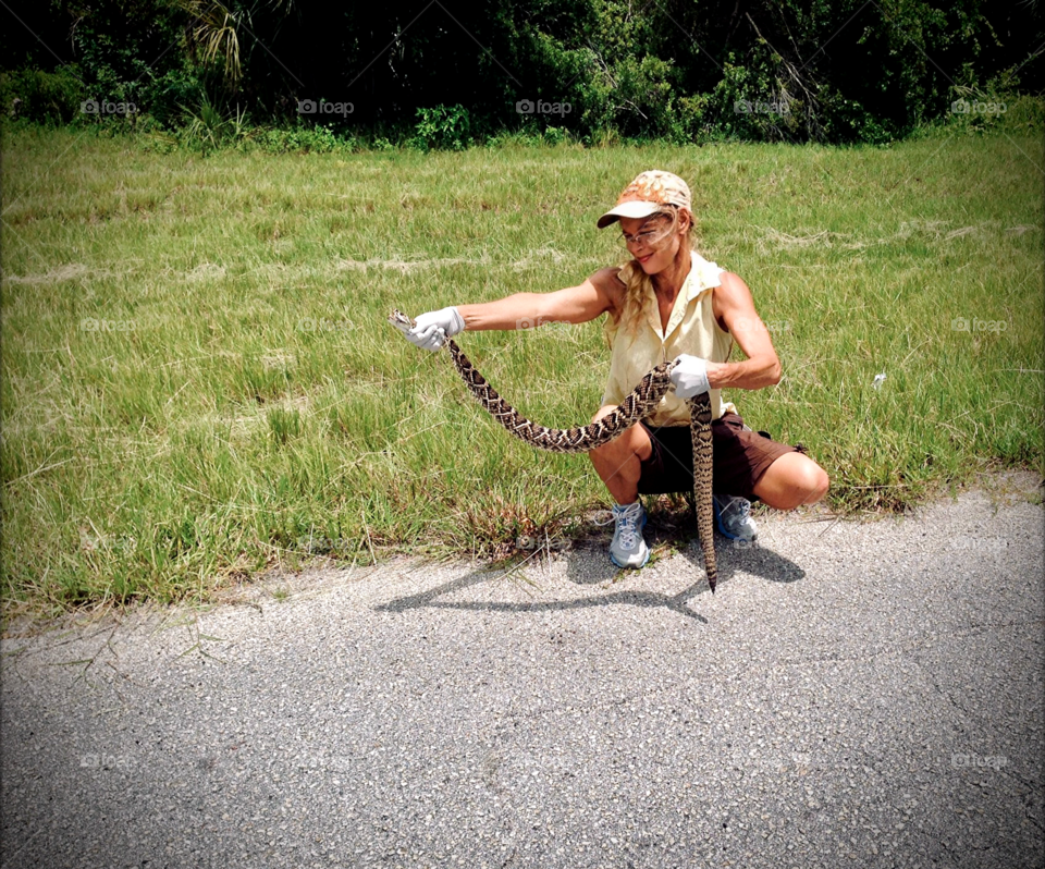 Woman holding an Eastern Diamondback Rattlesnake.