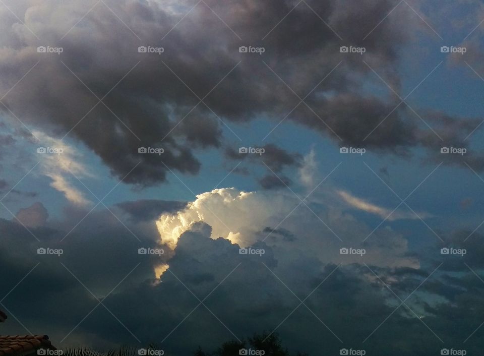 Fluffy white cloud amid storm clouds