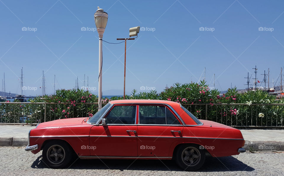 a red car on a blue sky background