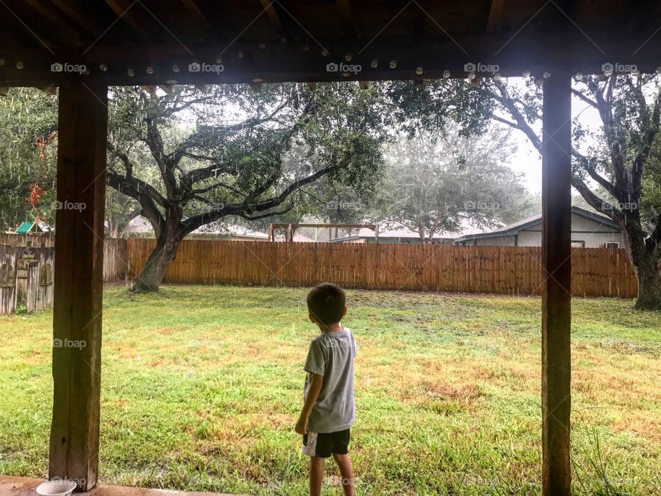 My son touching the rain. 