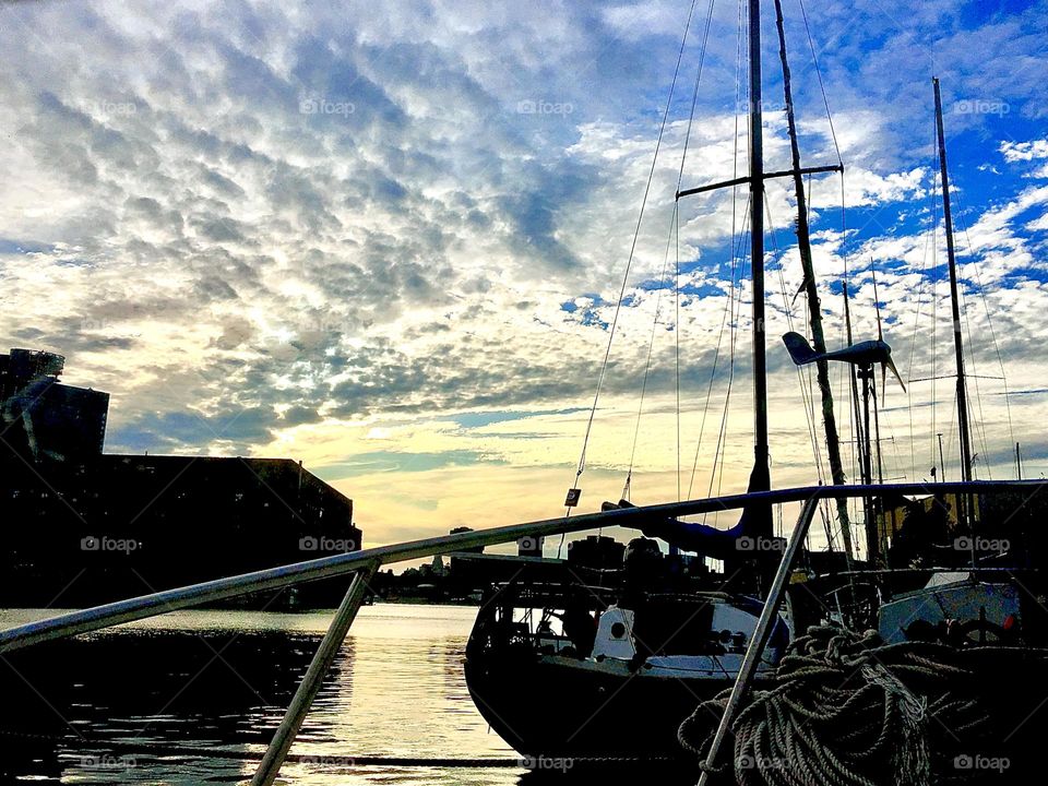 A dramatic view of Newtown Creek in Long Island City, Queens, NY underneath a cloudy sky during the evening hours of sunset and upcoming nightfall photographed in 2021. Hypnotic Productions