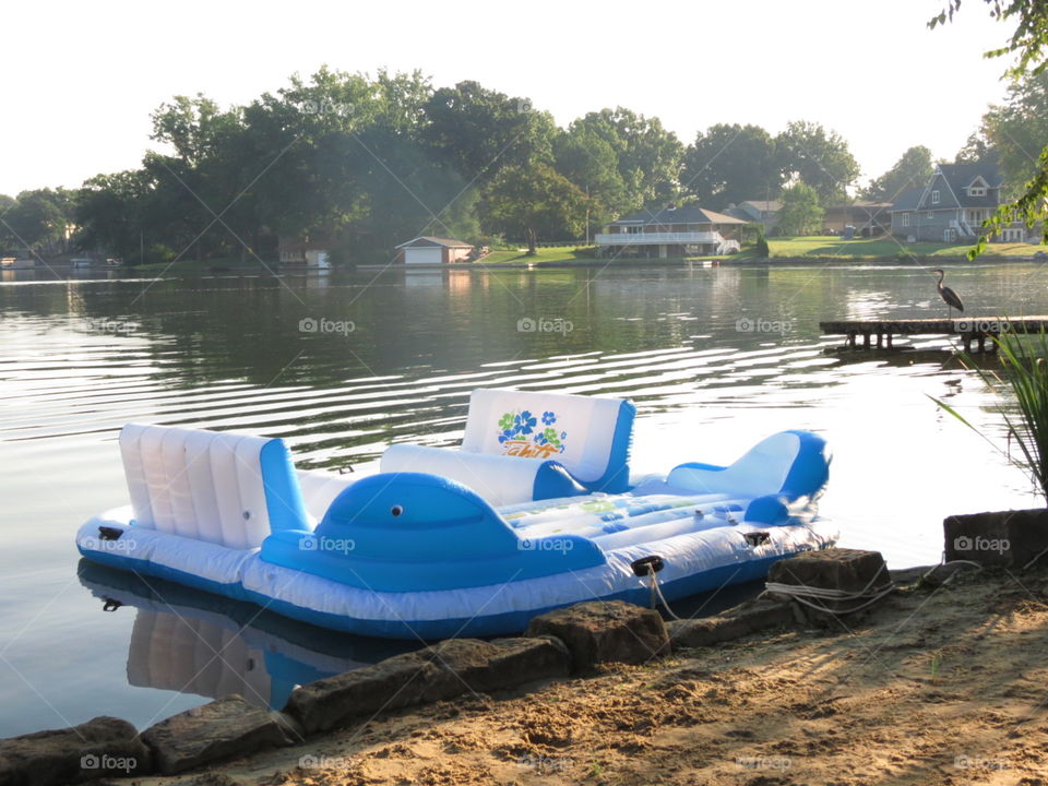 Inflatable pontoon raft and a heron