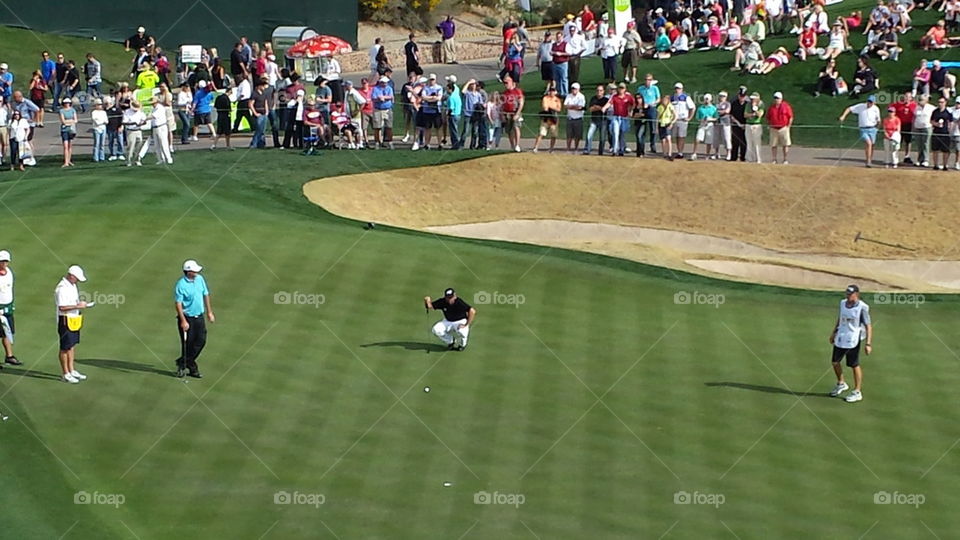 Golfer lines up shot 