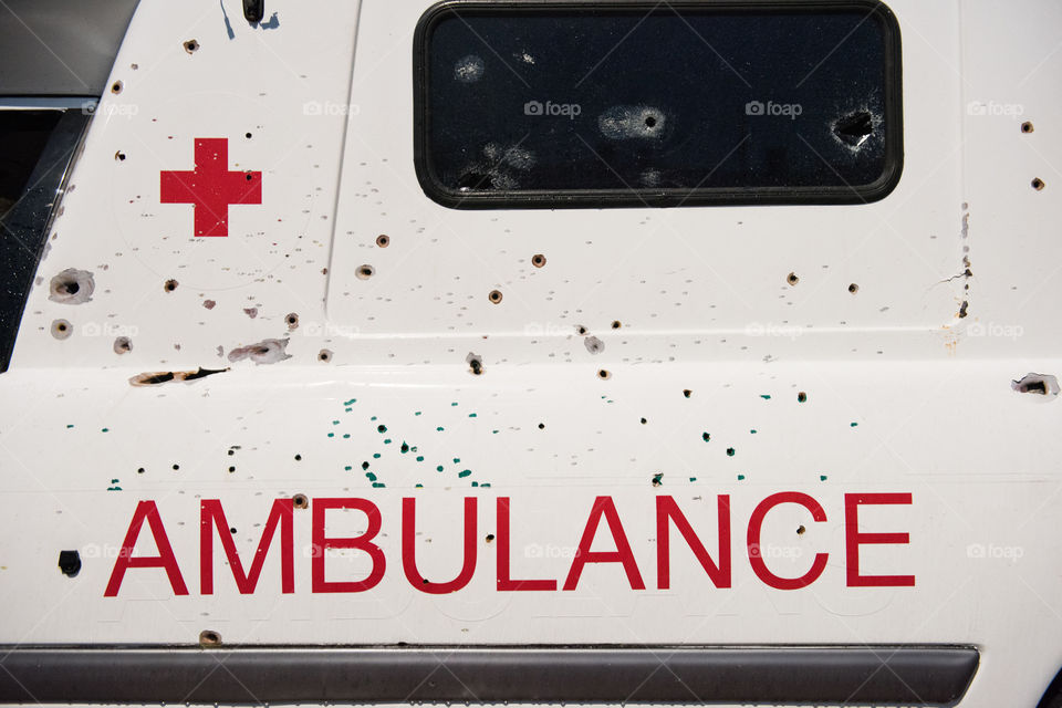 A real ambulance from the Red Cross who had been attacked in war. The Ambulance has bulletholes just everywhere and even firebombs have been thrown against it. The ambulance is part of efforts to make people aware of what happens in war. Ambulance shown up in various parts of the world. The picture is from Malmö Sweden.