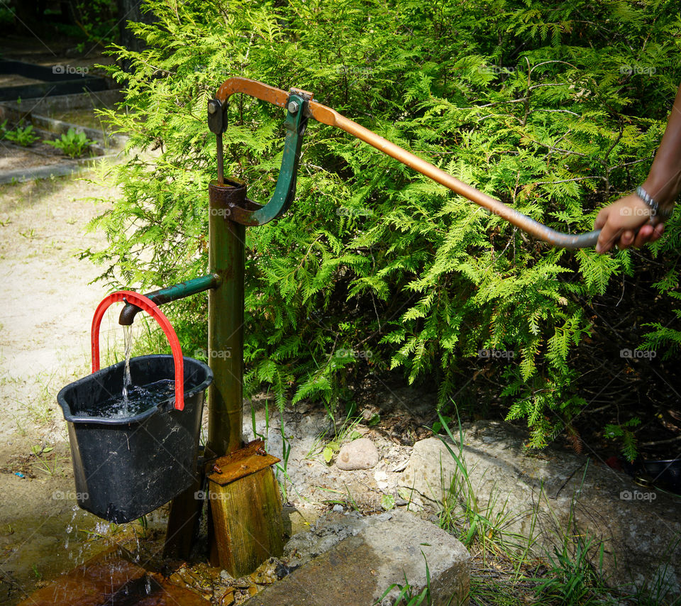 old hand operated water pump in action