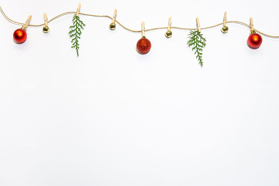 Christmas layout branches bells and red decoration. flat lay