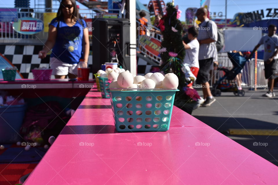 Playing at a carnival game booth