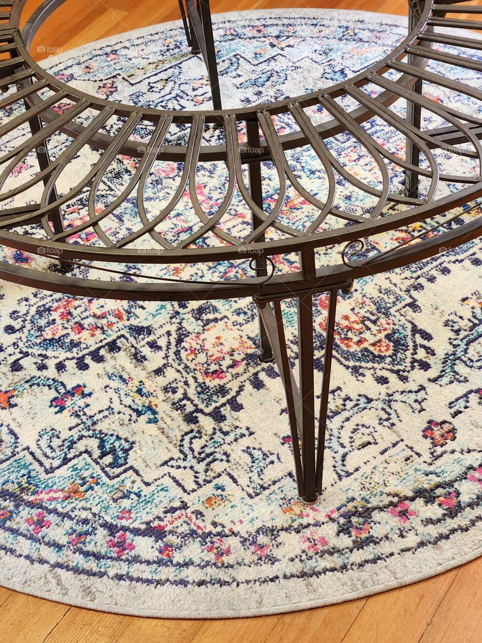 ornate round metal table on floral rug