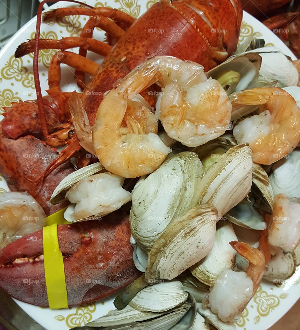 New England Clambake with steamed lobster, shrimp, and steamer clams.