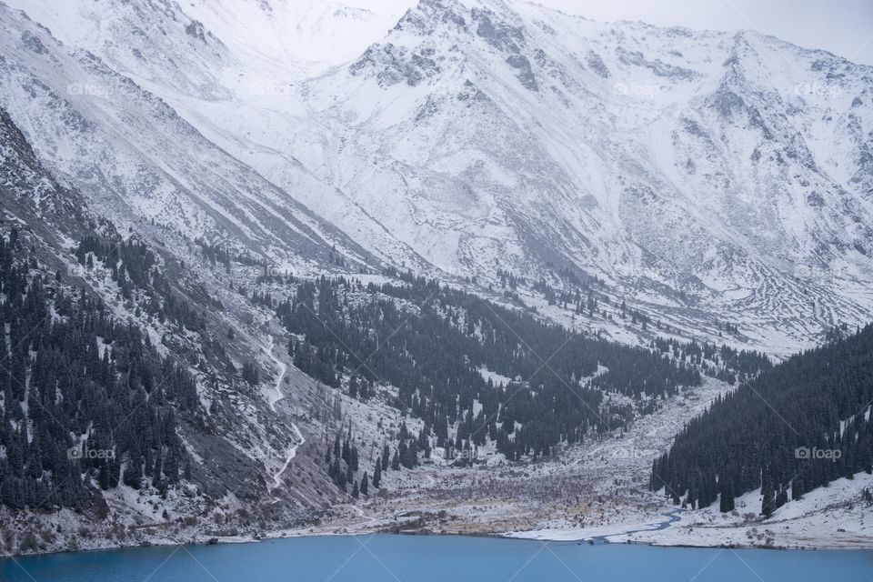 Snow on the mountain and pine forest at big Almaty lake Kazakhstan