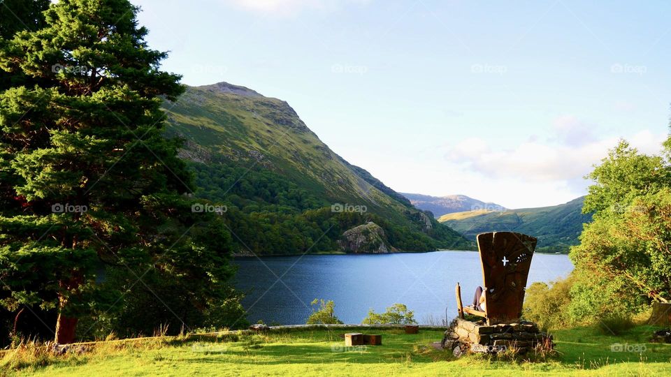 Wooden giant chair viewing lake between the mountains 