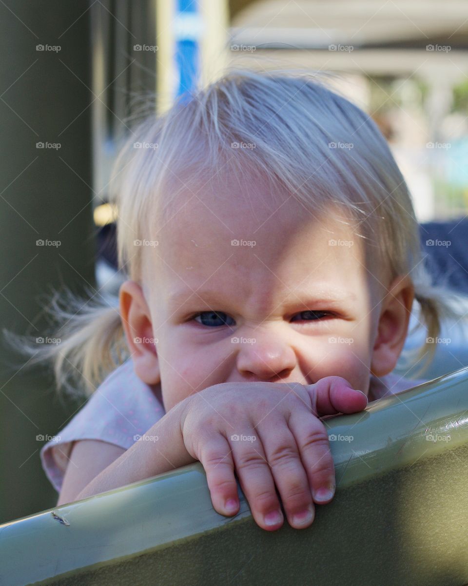 A beautiful baby girl making her funny pirate scowl face