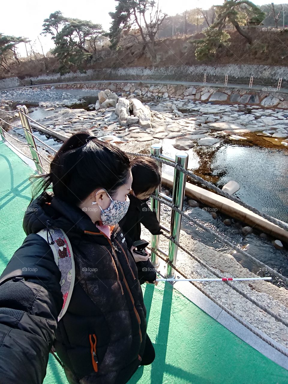 my girl want to touch that water in the river but its a cliff and its far that its impossible to reach. the fence is also there blocking our way as a protection.
