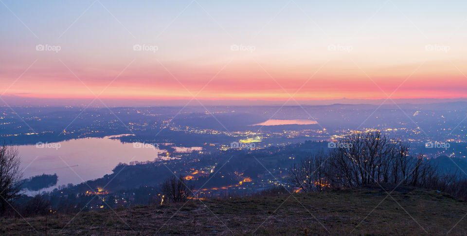 beautiful sunset over the flat land viewed from the top of a mountain in winter time