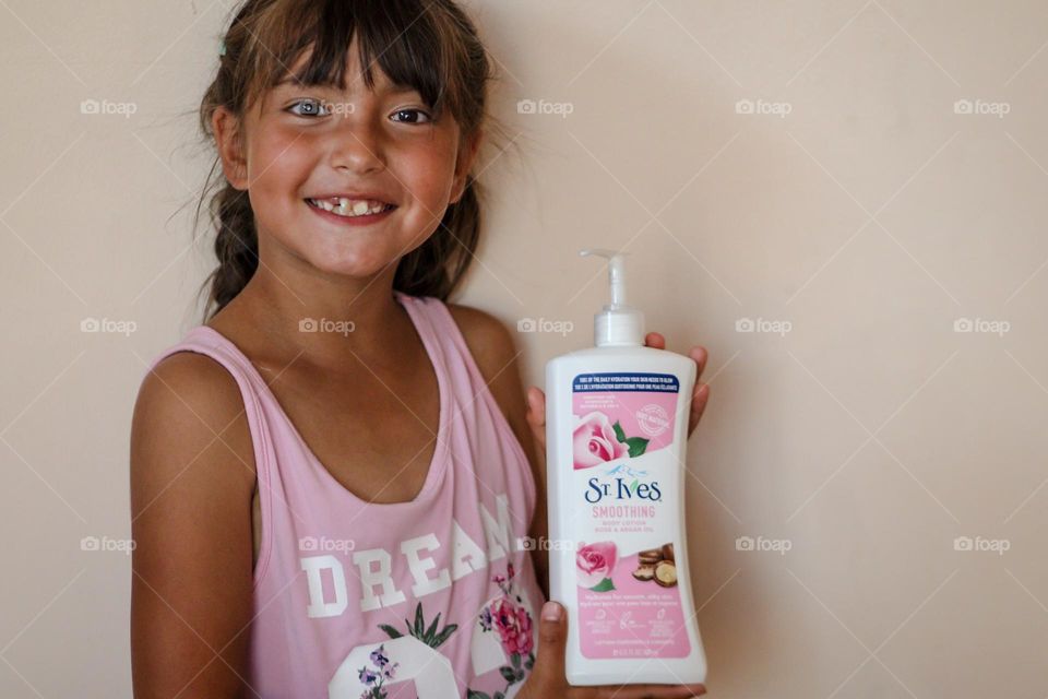 Cute little girl with St.Ives product in her hands