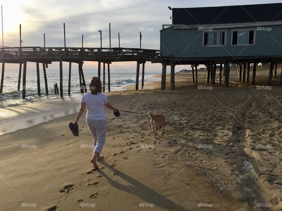 Sunrise walk on the beach with the dog