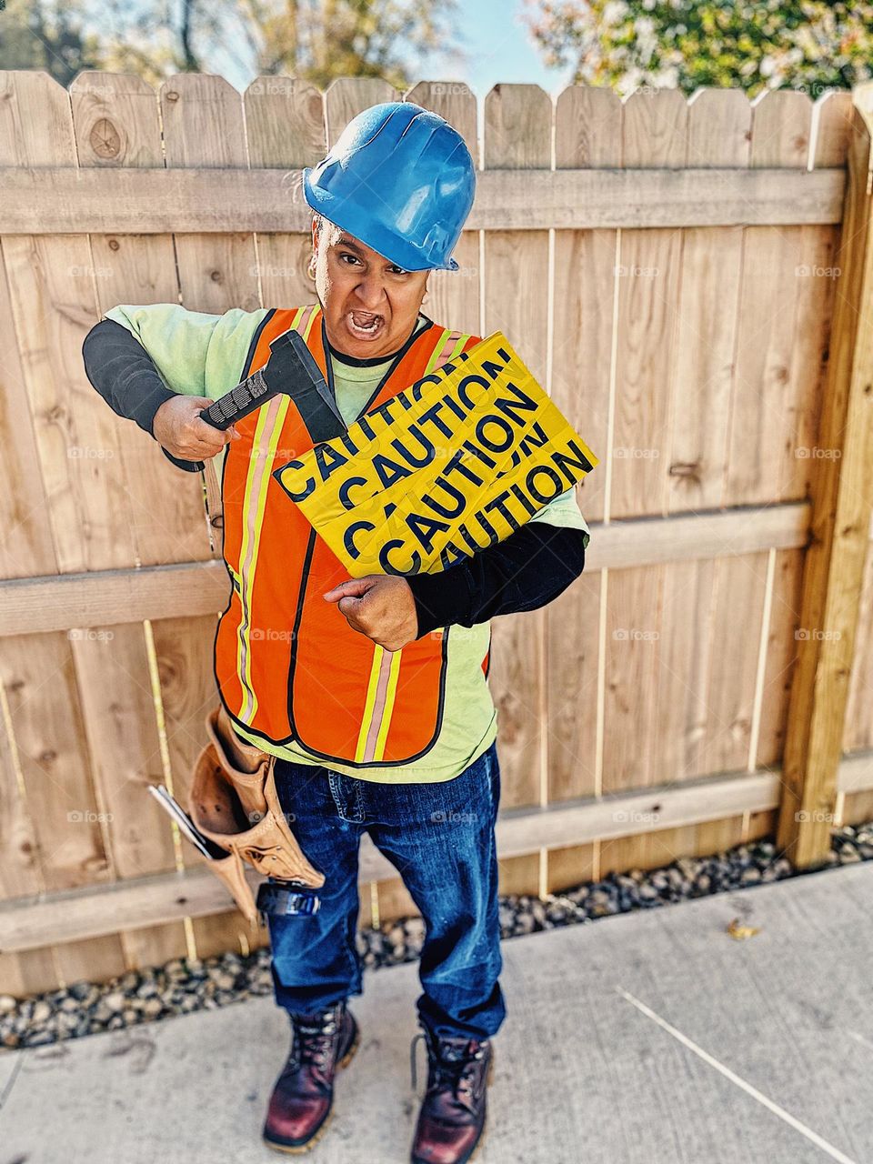 Woman dresses as construction worker for Halloween, woman ready for trick or treat, wearing costumes on Halloween, trick or treat night with kids, having fun with family themed costumes, construction workers costumes 