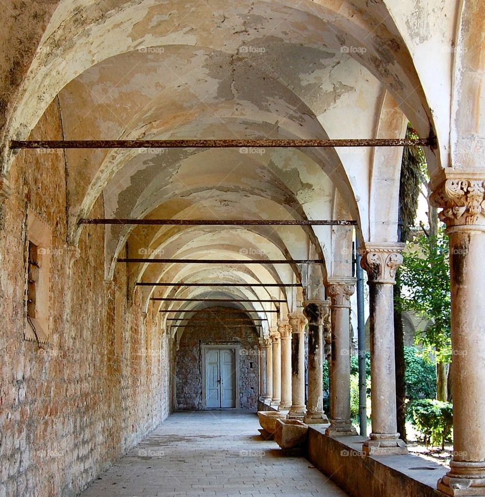 Passageway in Lokrum Croatia showing arches with shadows and light on a sunny summer day. 