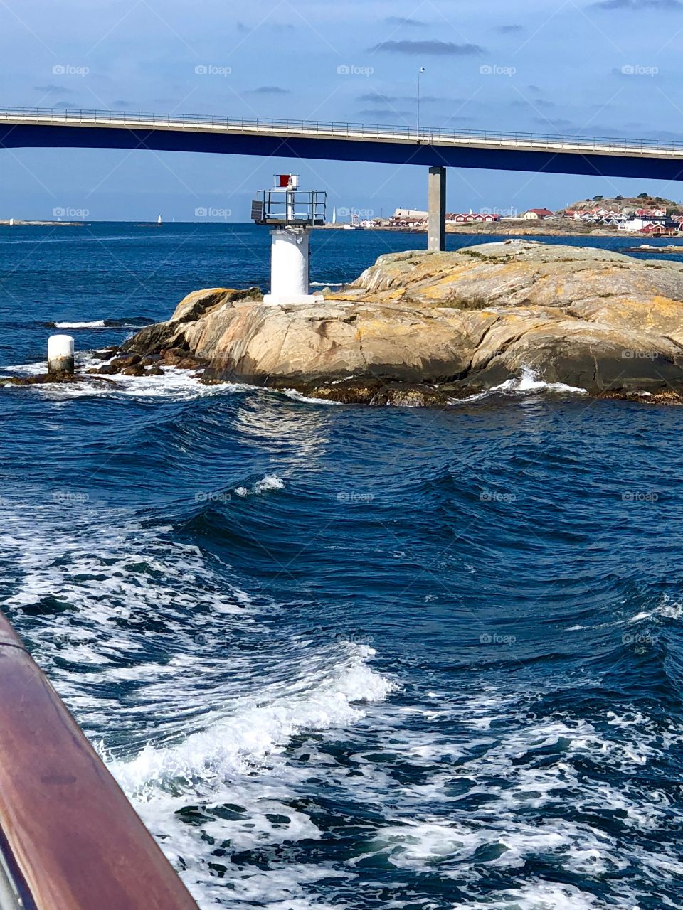 Passing under a bridge and a lighthouse 