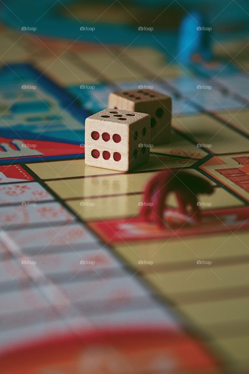 Dice on a board game, Parcheesi board game, pawns on the board game, closeup of a classic game, die on a board game, playing games at home, board games with kids, family time at home